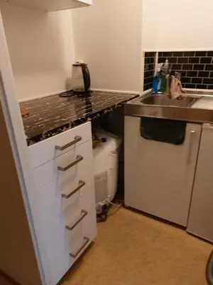 a kitchen with a sink and a counter top at Cozy room away from home in Åmot