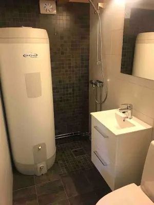 a small bathroom with a toilet and a sink at Bjønnhiet in Trysil