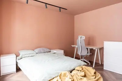 a bedroom with a bed and a desk and a chair at Large apartment in historical street in Bergen