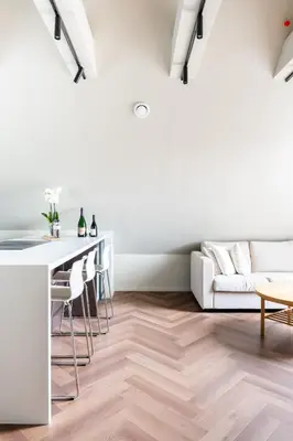 a white living room with a table and a couch at Large apartment in historical street in Bergen