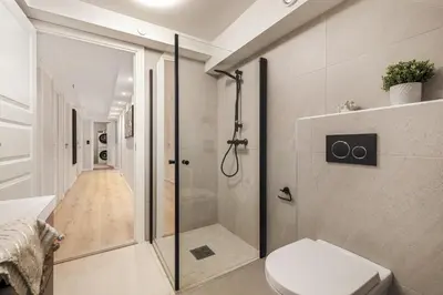 a bathroom with a shower and a toilet at Rosenberg Apartments in Bergen