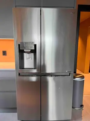 a stainless steel refrigerator in a kitchen at Luxury apartment with beautiful location in Florvåg