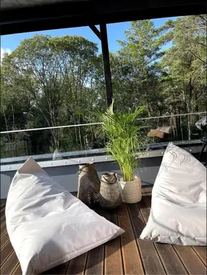 two white pillows sitting on a wooden deck at Luxury apartment with beautiful location in Florvåg