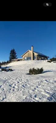a building on top of a snow covered field at Birkenstua in Ringsaker