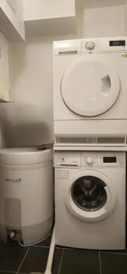 a bathroom with a washing machine and a sink at Øvregaten in Bergen
