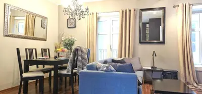 a living room with a blue couch and a table at Øvregaten in Bergen