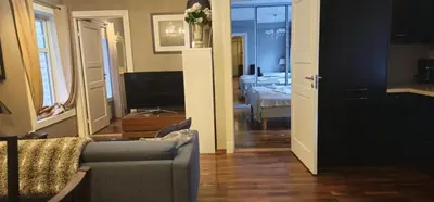 a living room with a couch and a bedroom at Øvregaten in Bergen