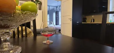 a glass of red wine sitting on a table at øvregaten in Bergen