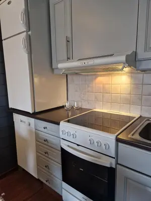 a kitchen with white cabinets and a stove top oven at Storehorn Apartments Hemsedal in Fausko