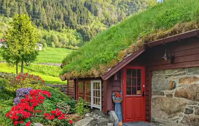 a house with a grass roof with a red door at Nice Home In Stårheim With Wifi in Stårheim