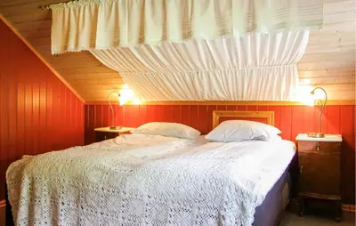 a bedroom with a large bed with red walls at Nice Home In Stårheim With Wifi in Stårheim
