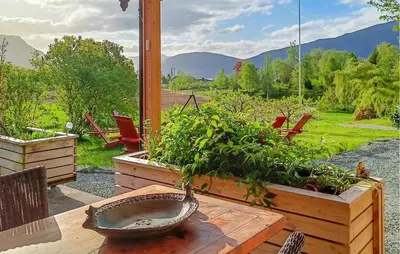 a patio with a table with plants and chairs at Nice Home In Stårheim With Wifi in Stårheim