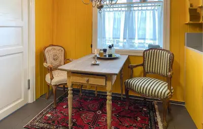 a dining room with a table and two chairs at Nice Home In Stårheim With Wifi in Stårheim