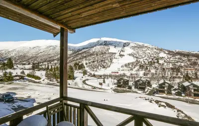 a view from the balcony of a ski resort with snow covered mountains at 2 Bedroom Cozy Apartment In Stranda in Stranda