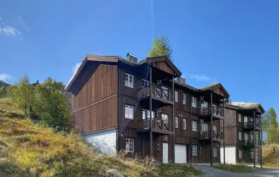 a large wooden building with balconies on a hill at 2 Bedroom Cozy Apartment In Stranda in Stranda