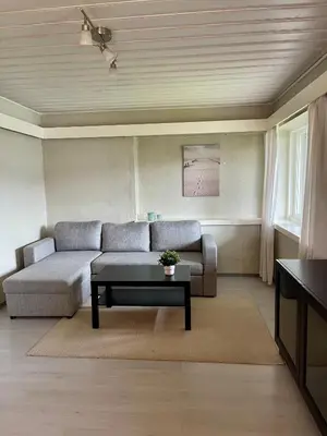 a living room with a couch and a table at Sjøutsikt in Bergen