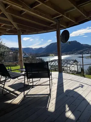 two chairs on a deck with a view of the water at Sjøutsikt in Bergen