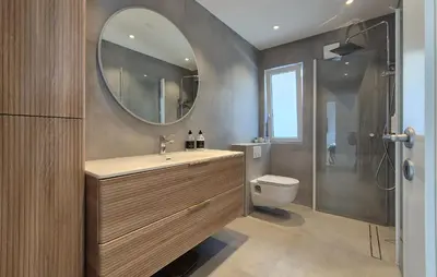 a bathroom with a sink and a toilet and a mirror at Lovely Home In Mosterhamn With Sauna in Mosterhamn