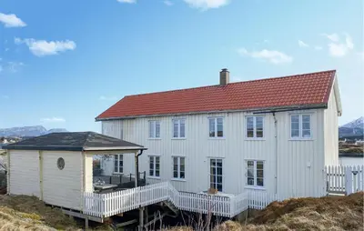 a white house with a red roof on a hill at Amazing Home In Averøy With Wifi in Averoy