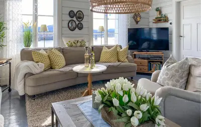 a living room with a couch and a table with flowers at Amazing Home In Averøy With Wifi in Averoy