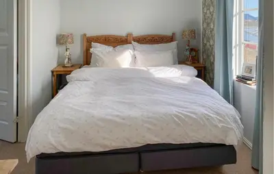 a bedroom with a large bed with white sheets and pillows at Amazing Home In Averøy With Wifi in Averoy