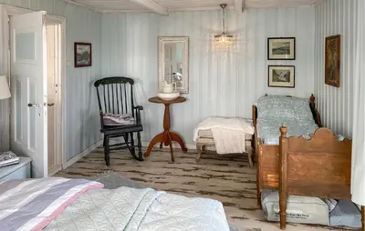a bedroom with a bed and a chair and a table at Amazing Home In Averøy With Wifi in Averoy