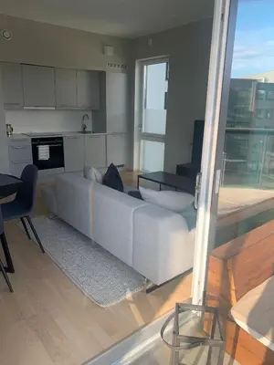 a living room with a couch and a table at Bølgen Nyhavna in Trondheim