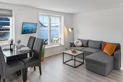 a living room with a couch and a table at Komfortable Ferieleiligheter med Sjøutsikt in Stadlandet