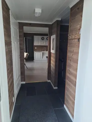 a hallway of a home with wood paneling and a desk at Apartment Tråstølen ski in ski out in Vossevangen
