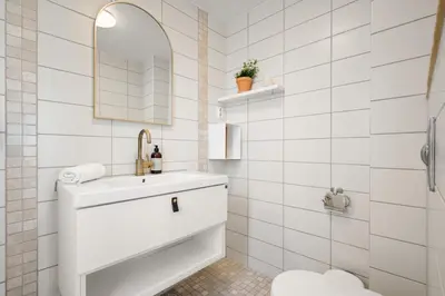a white bathroom with a sink and a toilet at Bergen Gem Straight Out of History - Built in 1750 in Bergen