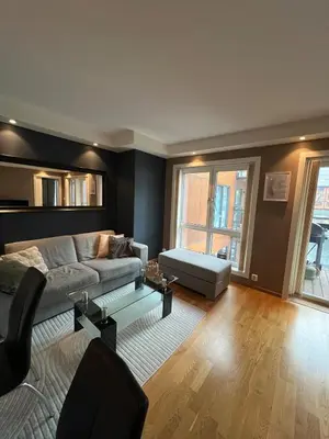 a living room with a couch and a table at Centrally located apartment in Bergen