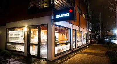 a jumeo store on the side of a building at night at Centrally located apartment in Bergen