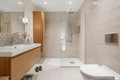 a bathroom with a shower and a toilet and a sink at Villa Vy - a gem with private beach in Bergen in Bergen