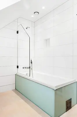 a bathtub in a bathroom with white walls at DINBNB Apartments l Luxury Penthouse l Roof Terrace l Central Bergen in Bergen