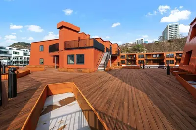 a building with a wooden deck in front of a building at Helt NY leilighet, Ytre Sandviken i Bergen in Bergen