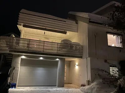a building with a garage at night at Lars sitt hus in Lillehammer