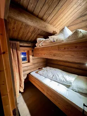 a bedroom with two bunk beds in a log cabin at The Heritage Lodge - Geilo in Geilo