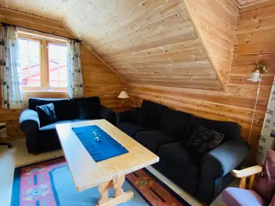 a living room with a couch and a table at Mo Laksegard in Sand