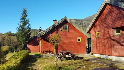 a red barn with a picnic table in front of it at Mo Laksegard in Sand