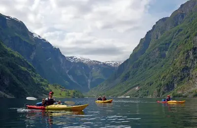 a group of people kayaking on a river in a valley at Large single-family home - Central in Voss in Vossevangen