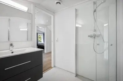 a bathroom with a glass shower and a sink at Large single-family home - Central in Voss in Vossevangen
