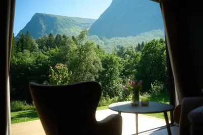 a room with a table and a view of a mountain at Hytte Blåtind, Rekkedal Gjestegard - Sæbø in Sæbø