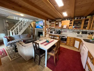 a kitchen and living room with a table and a couch at Knirkenheimen in Trondheim