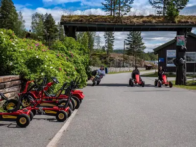 a group of people riding scooters down a road at Aurdal Fjordcamping og Hytter in Aurdal