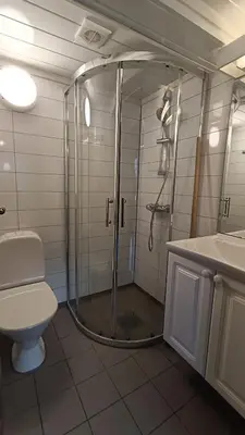 a bathroom with a shower and a toilet and a sink at Aurdal Fjordcamping og Hytter in Aurdal