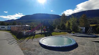 a playground with two trampolines and a playground at Aurdal Fjordcamping og Hytter in Aurdal