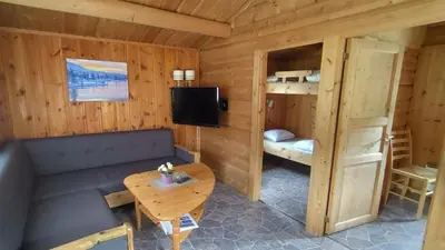 a room with a couch and a table and a bunk bed at Aurdal Fjordcamping og Hytter in Aurdal