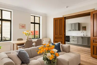a living room with a couch and a table with flowers at HH - Modern Apartments l City Center in Bergen