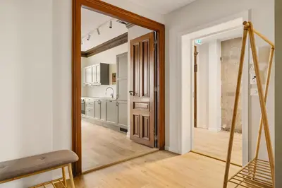 a hallway with a mirror and a kitchen at HH - Modern Apartments l City Center in Bergen