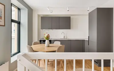 a kitchen and dining room with a wooden table at HH - Modern Apartments l City Center in Bergen